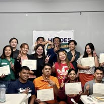 Bootcamp graduates holding their certificates of completion